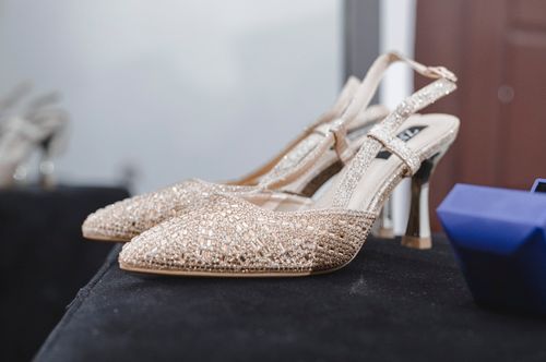 Free Close-up of glamorous sparkling high heels showcased on a table indoors. Stock Photo