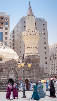 An ancient mosque in Madinah, Saudi Arabia with visitors depicting Islamic culture.