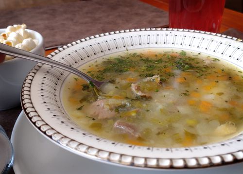 Free Warm bowl of homemade vegetable soup served with bread and drink. Stock Photo