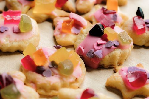 Free Vibrant cookies decorated with icing and candy pieces, perfect for celebrations. Stock Photo