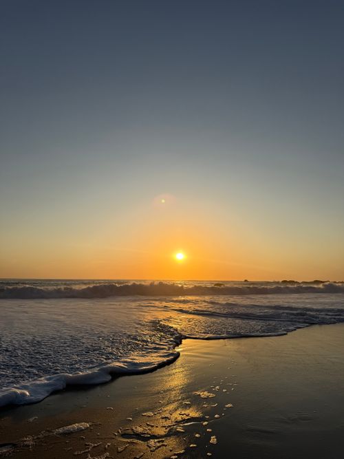 Free Calm beach sunset with gentle waves in Cape Town, South Africa. Stock Photo