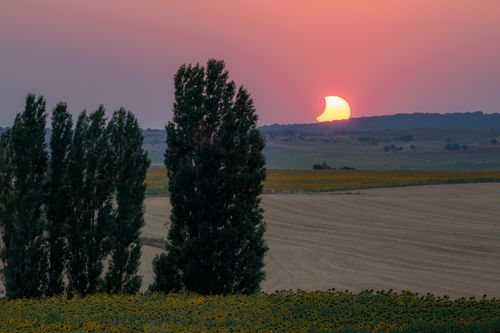 Free Stunning view of a solar eclipse setting over the fields of La Seca, Spain, creating a captivating silhouette effect. Stock Photo