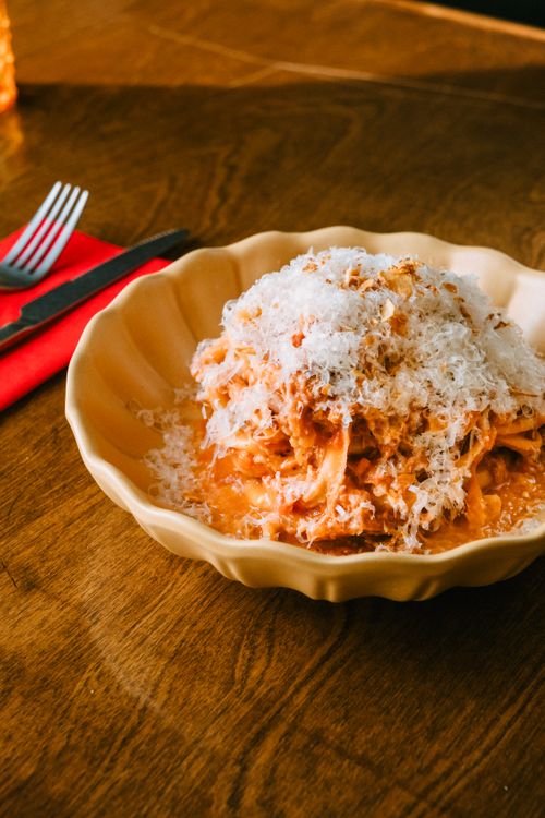 Free Close-up of tasty spaghetti bolognese topped with Parmesan cheese served at a cozy restaurant. Stock Photo