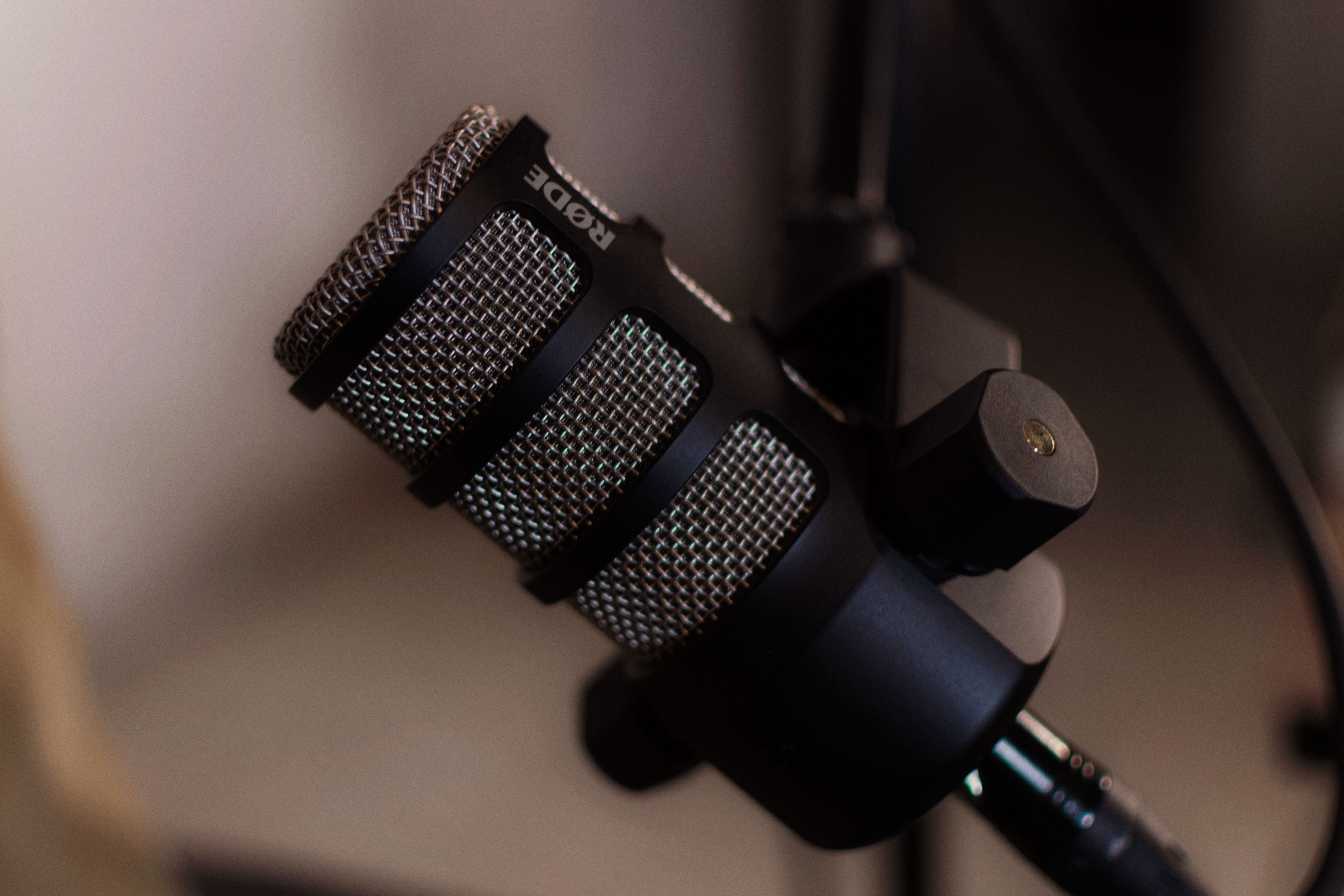 Detailed close-up of a RODE microphone in a professional studio environment, ideal for audio recording.