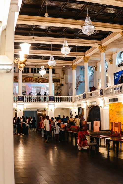 Free A busy cultural hall showcasing elegant architecture with people exploring exhibits in Kolkata, India. Stock Photo