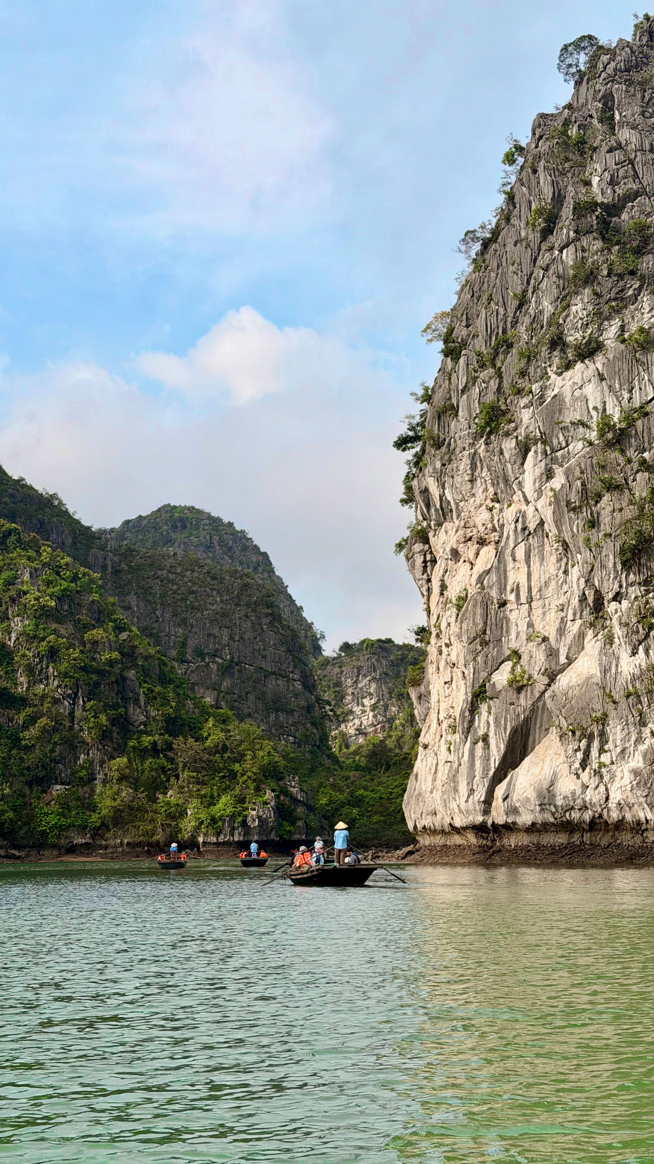 Explore the tranquil waters of Vietnam's stunning Lan Ha Bay with towering limestone cliffs and serene landscapes.
