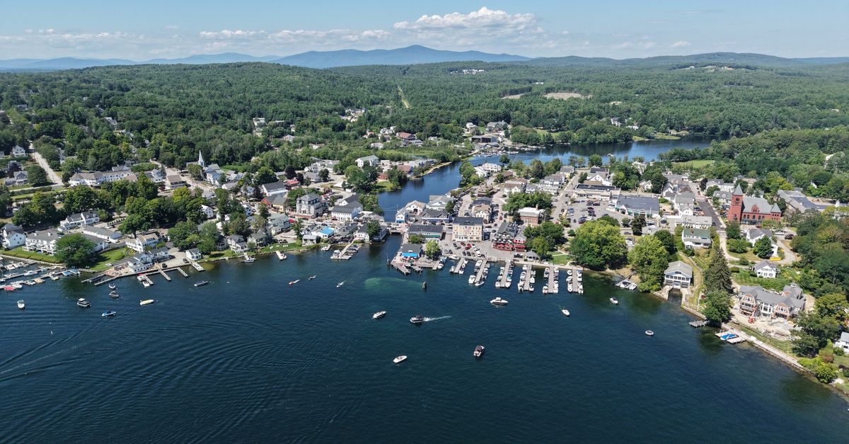 Scenic aerial shot of Wolfeboro, New Hampshire with boats on the lake and lush greenery.
