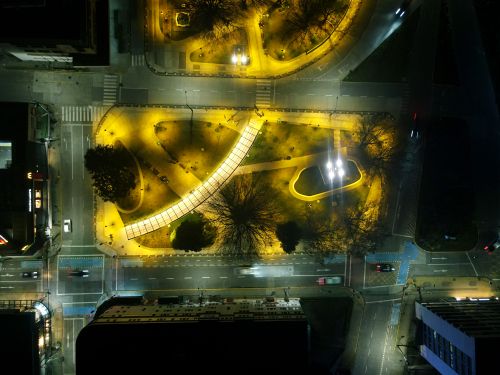 Free Overhead view of a brightly lit urban park intersection at night. Stock Photo