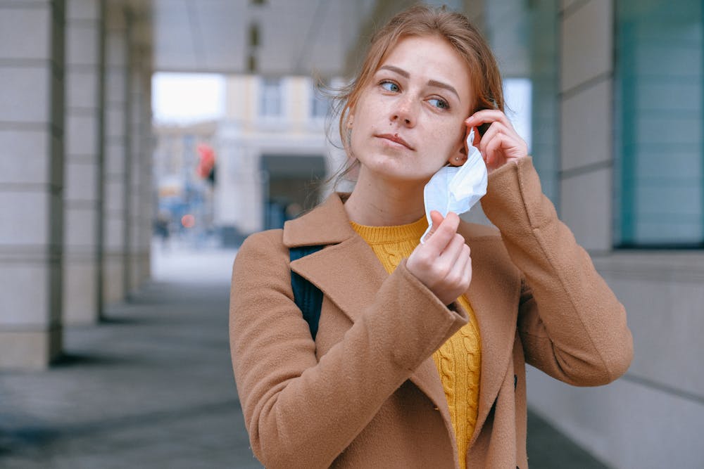 Woman removing a face mask