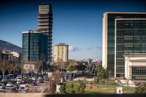 Free Vibrant urban cityscape of Izmir featuring modern high-rise buildings and bustling streets on a clear day. Stock Photo