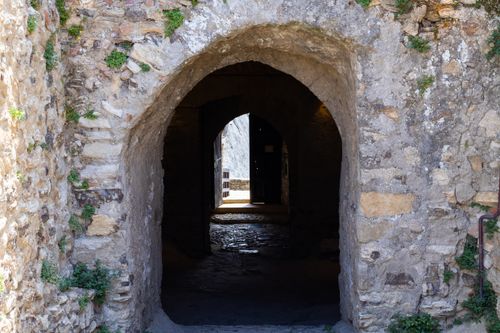 Free A captivating view through an ancient stone archway at Sperlinga Castle, Italy. Stock Photo