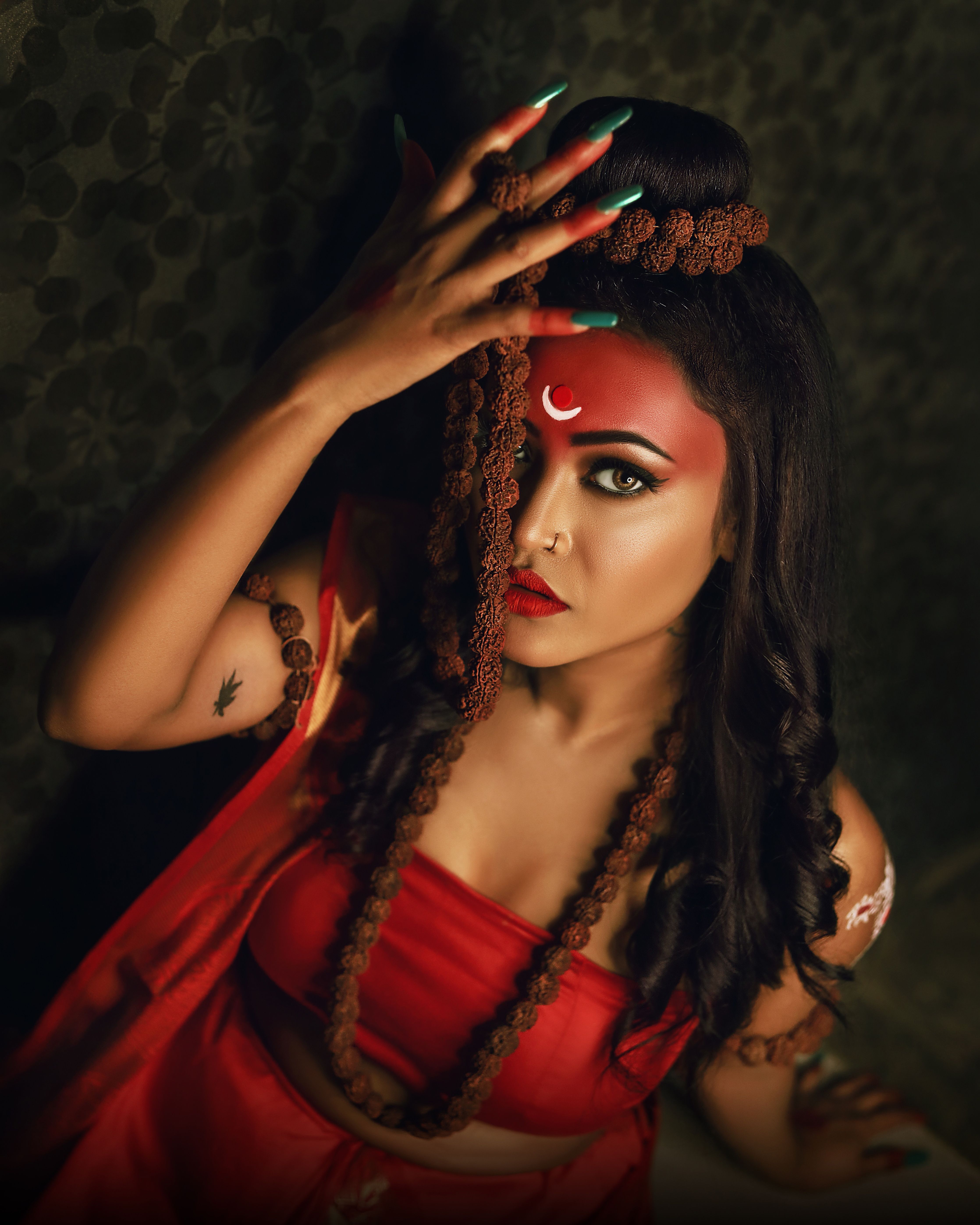 Cultural portrait of woman inspired by Hindu deity Shiva, showcasing traditional attire and symbolic elements.