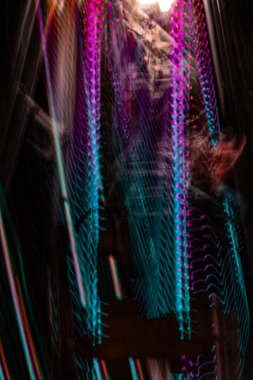 Free Colorful abstract image showcasing vibrant neon light trails and a bokeh effect creating a dreamy atmosphere. Stock Photo
