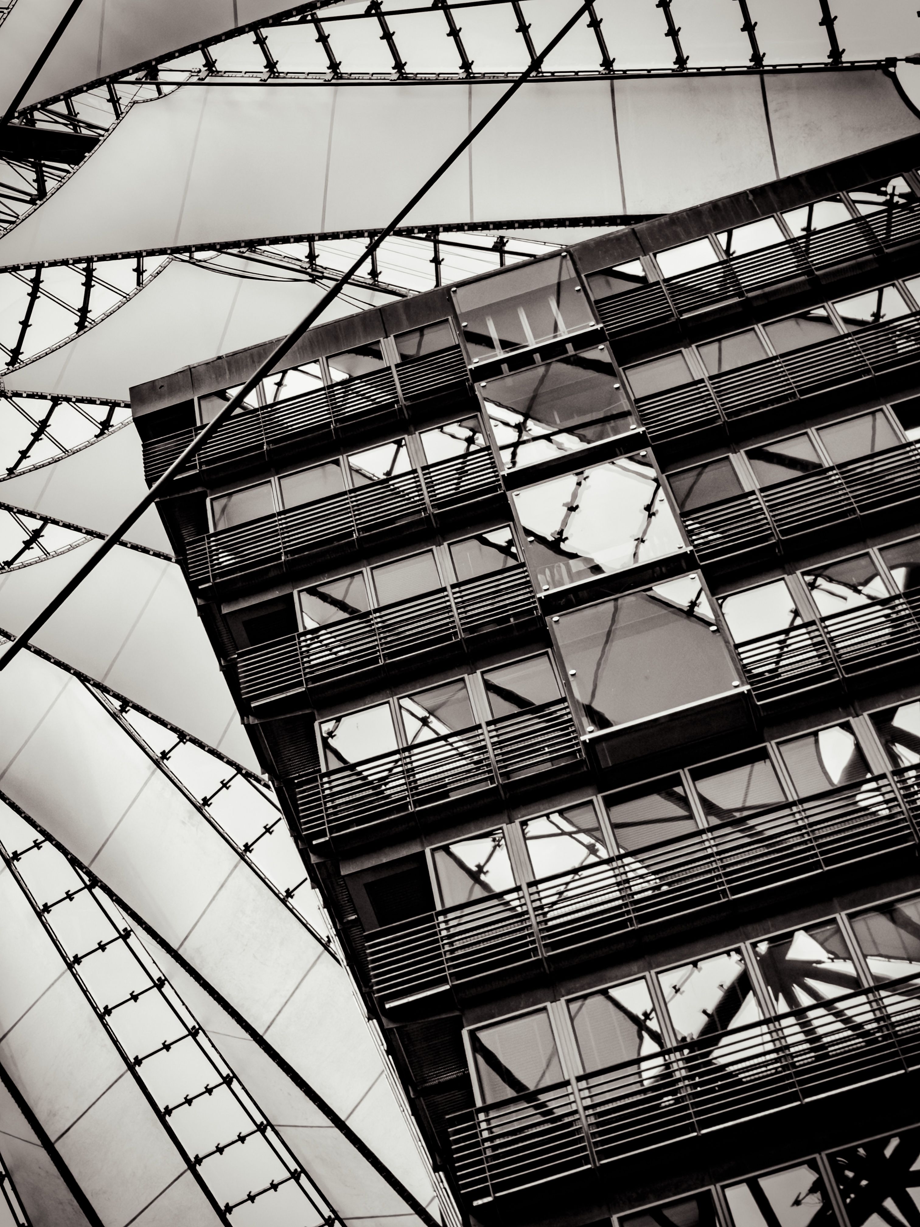 Abstract view of a modern architectural structure with glass panels and geometric lines.