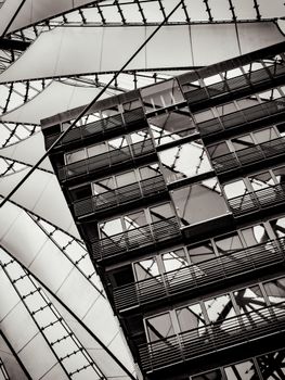 Abstract view of a modern architectural structure with glass panels and geometric lines.