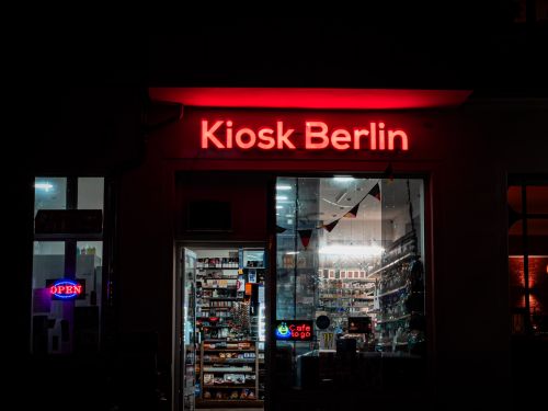 Free A vibrant night scene of Kiosk Berlin with illuminated signage and open storefront. Stock Photo