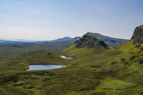 Free Breathtaking view of Quiraing mountains and lakes on the Isle of Skye, Scotland, under a clear blue sky. Stock Photo