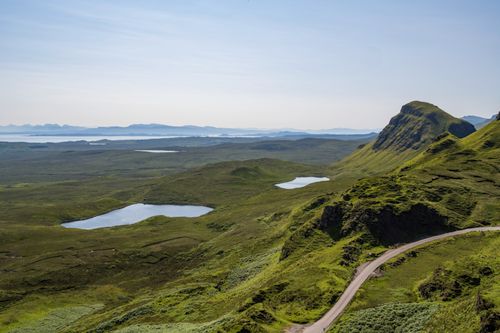 Free Explore the stunning Quiraing landscape with its lush greenery and serene blue lakes on the Isle of Skye, Scotland. Stock Photo