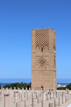 View of the ancient Hassan Tower in Rabat, Morocco with clear blue skies.
