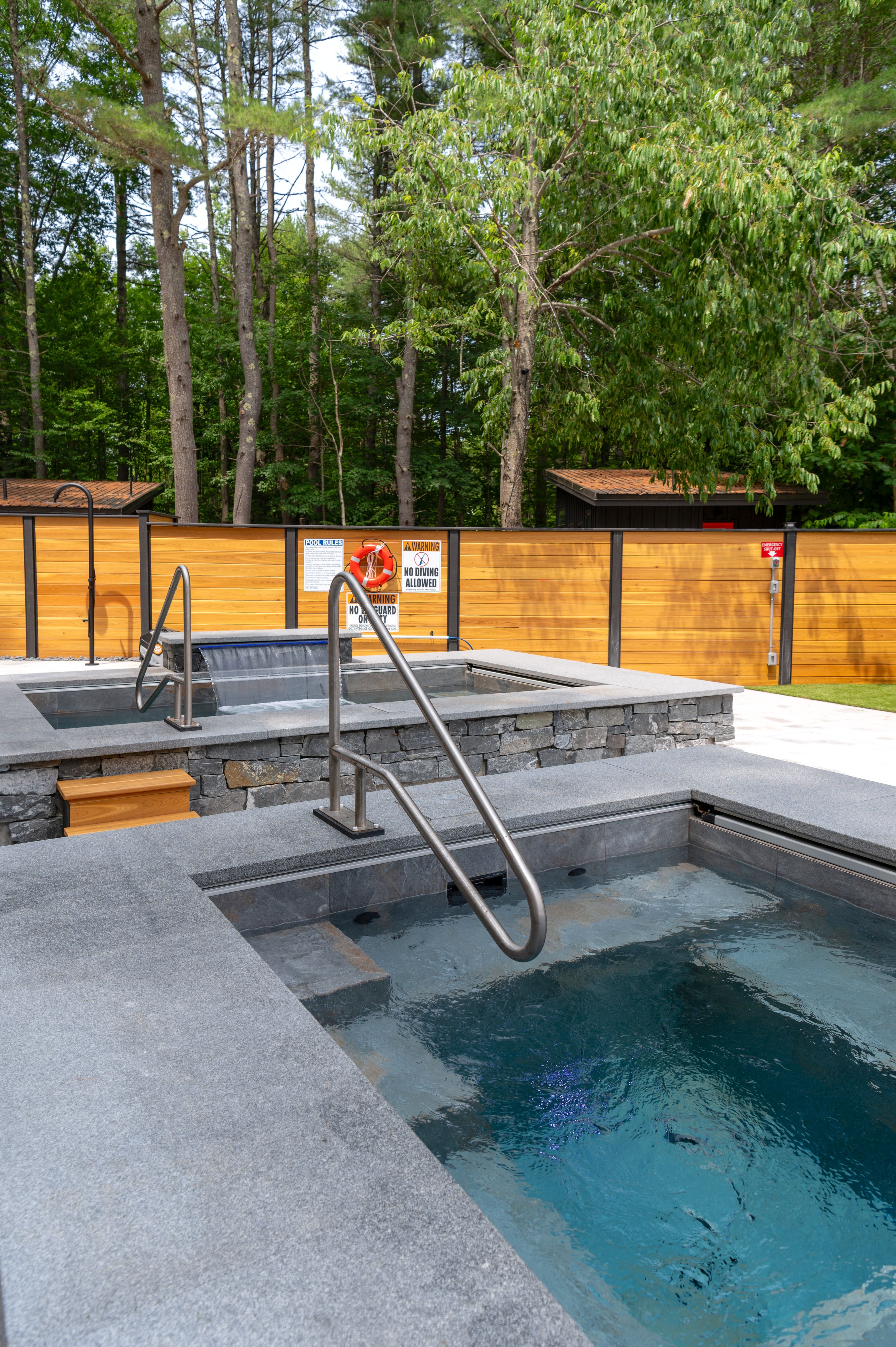 Modern outdoor hot tub surrounded by forest