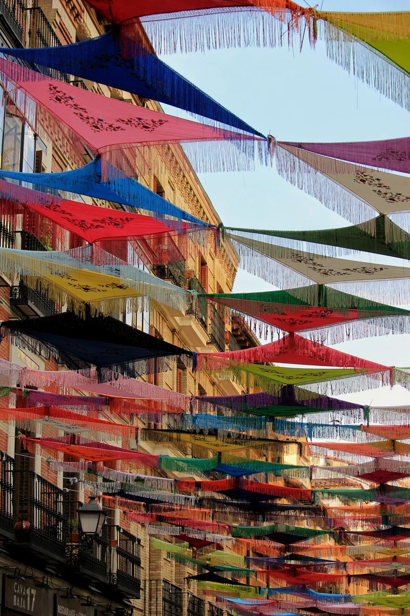 Colorful Spanish festival flags hanging in a Madrid street