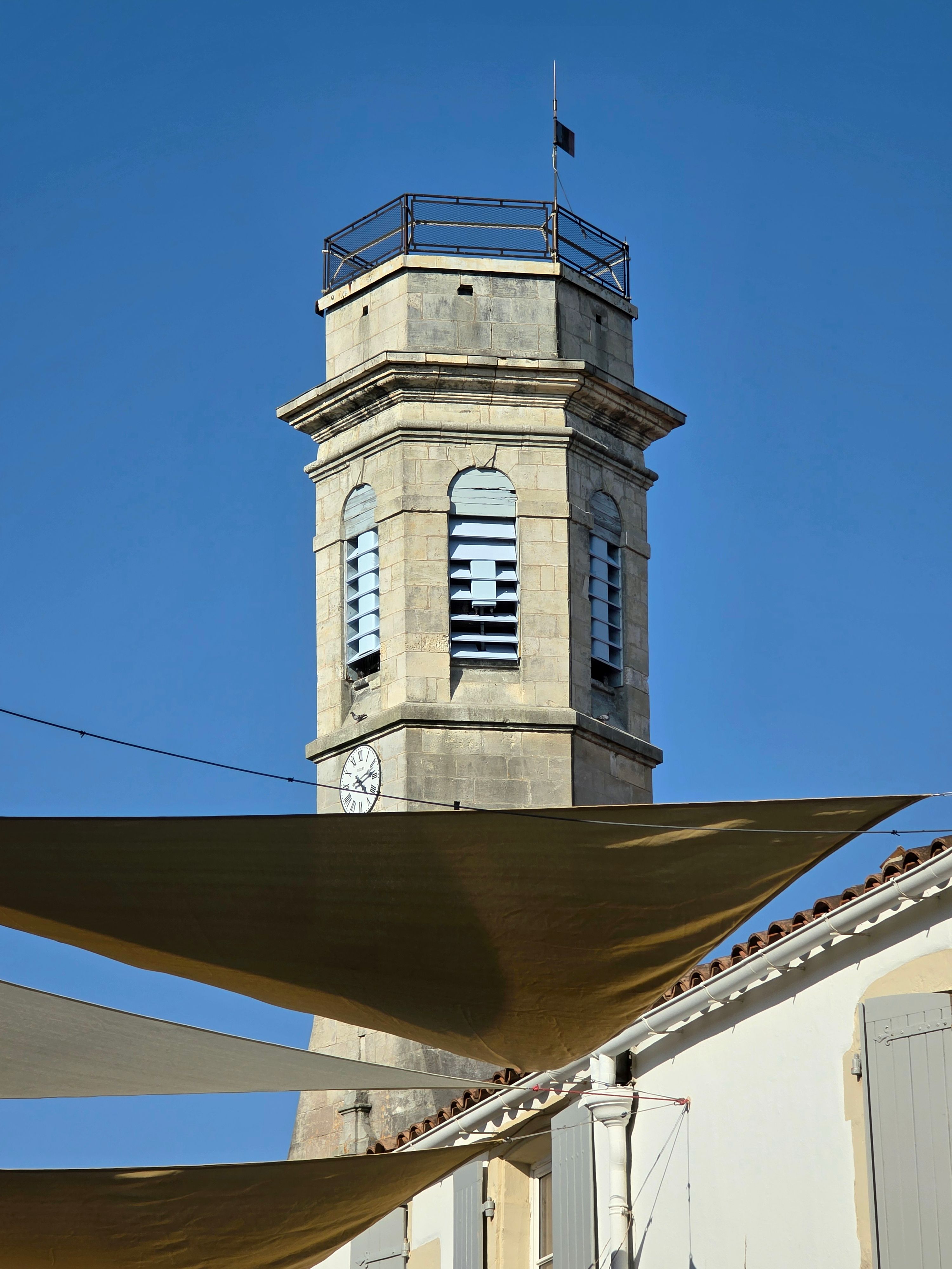 Scenic view of the Saint-Pierre-d'Oléron clock tower under blue sky.