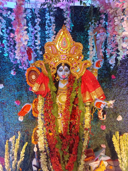Free Colorful and ornate Hindu goddess Durga idol with flowers during a festive celebration. Stock Photo