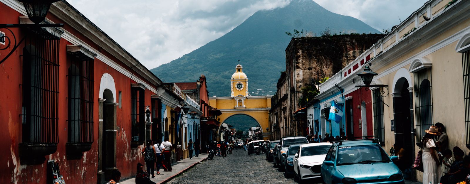 Picturesque street in Antigua Guatemala with Santa Catalina Arch and Agua Volcano. Perfect for travel and Latin American culture themes.