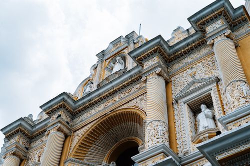 Free Detailed view of Baroque architecture on a historic church facade in Antigua, Guatemala, featuring intricate carvings. Stock Photo