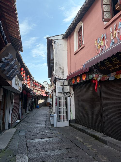 Free Quiet street scene in Suzhou capturing traditional Chinese architecture and cultural elements. Stock Photo