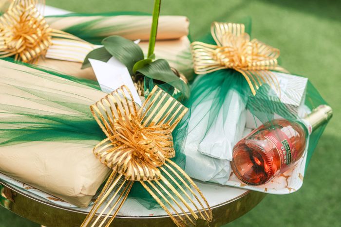 Luxury gift hampers wrapped in green and gold