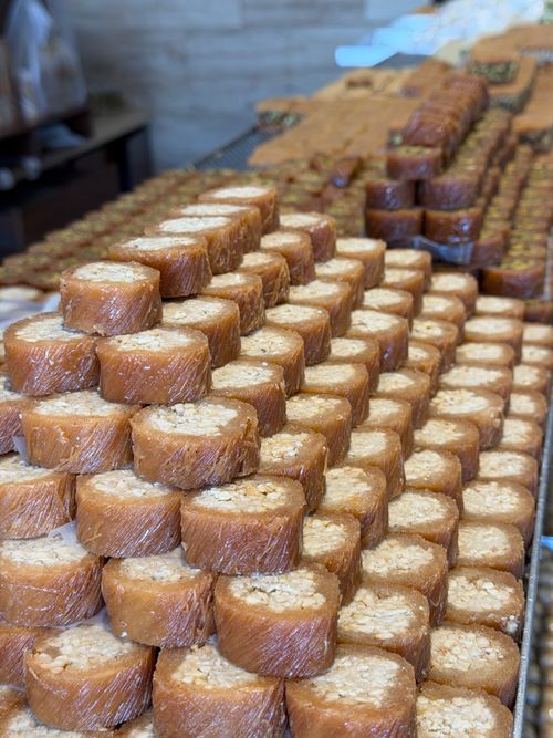 Free Rows of Lebanese baklava with nuts in a bakery. Perfect for food photography and cultural themes. Stock Photo