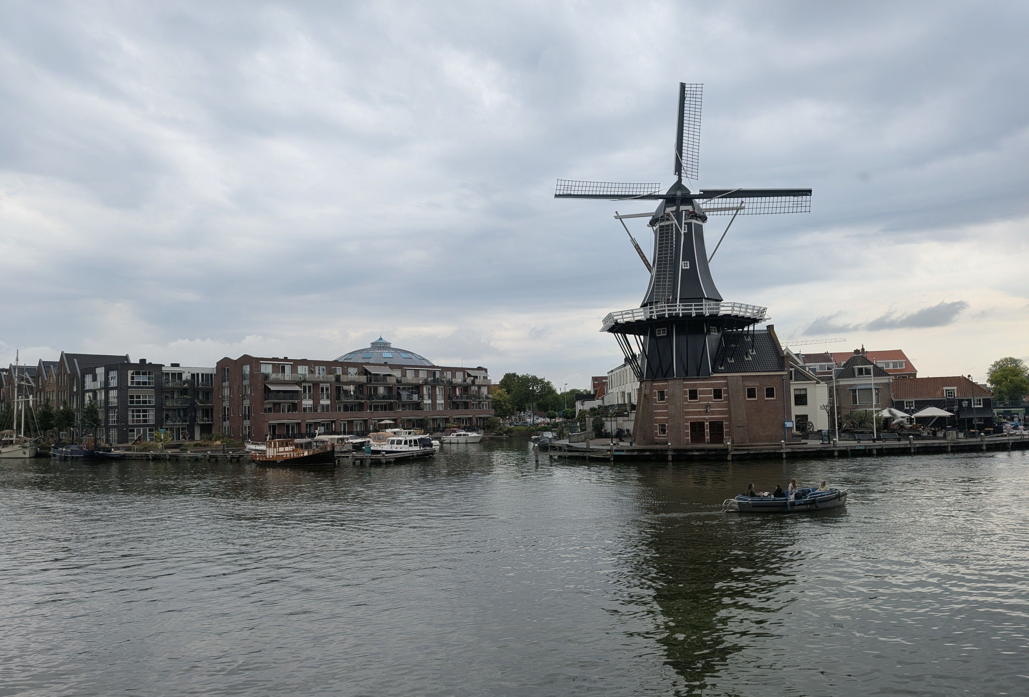 Scenic view of the iconic Molen de Adriaan windmill by the Spaarne River in Haarlem, Netherlands.