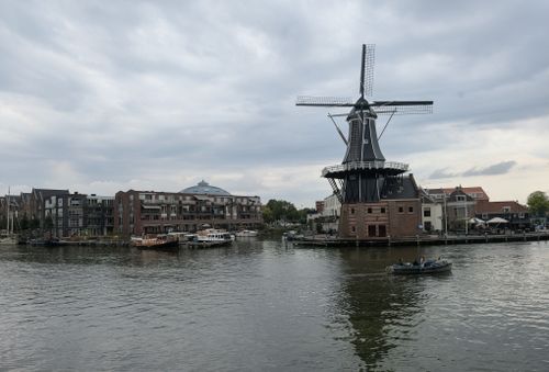 Free Scenic view of the iconic Molen de Adriaan windmill by the Spaarne River in Haarlem, Netherlands. Stock Photo