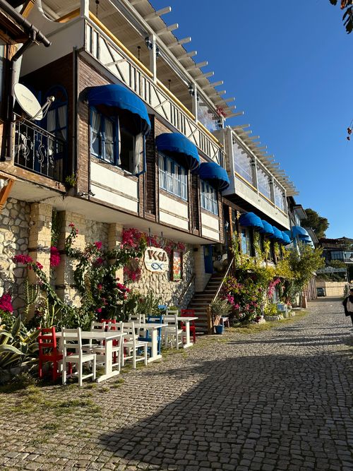 Free Coastal street with traditional Balkan architecture and vibrant floral decor in Old Nessebar, Bulgaria. Stock Photo