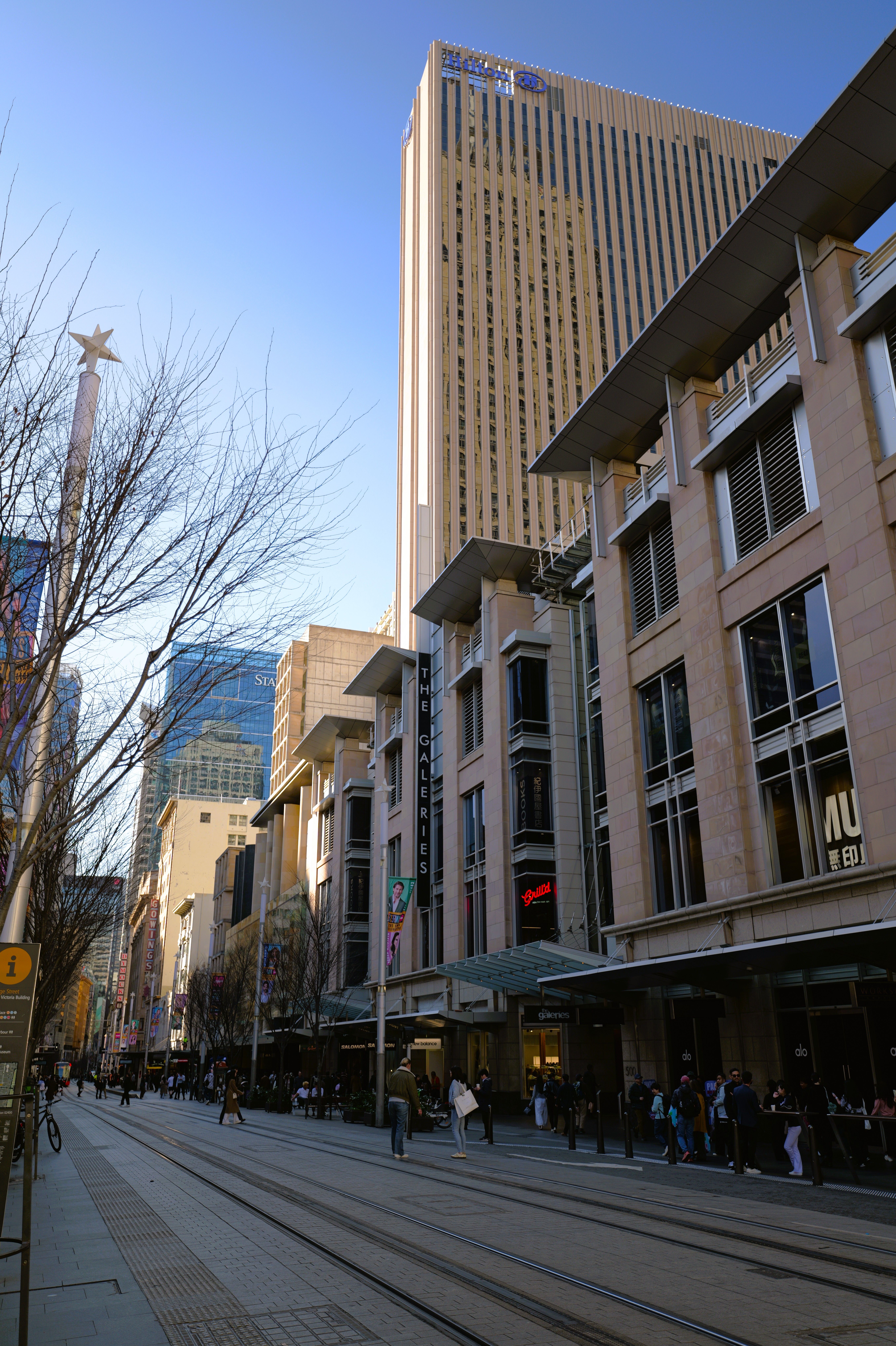 Sunny day capturing vibrant street life in downtown Sydney, Australia.