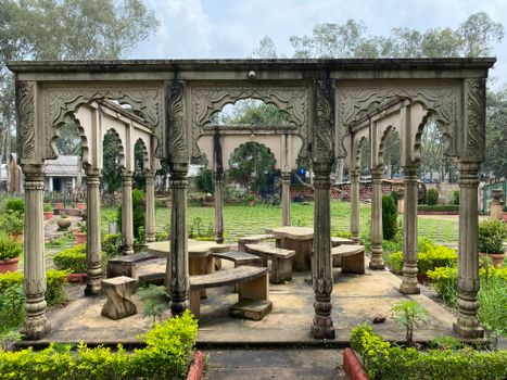 Elegant stone pavilion surrounded by lush gardens in Pachmarhi, India.