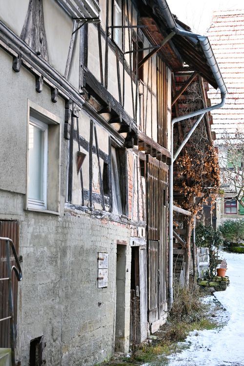 Free Discover a quaint historical alleyway in Baden-Württemberg, Germany showcasing aged timber-framed houses. Stock Photo
