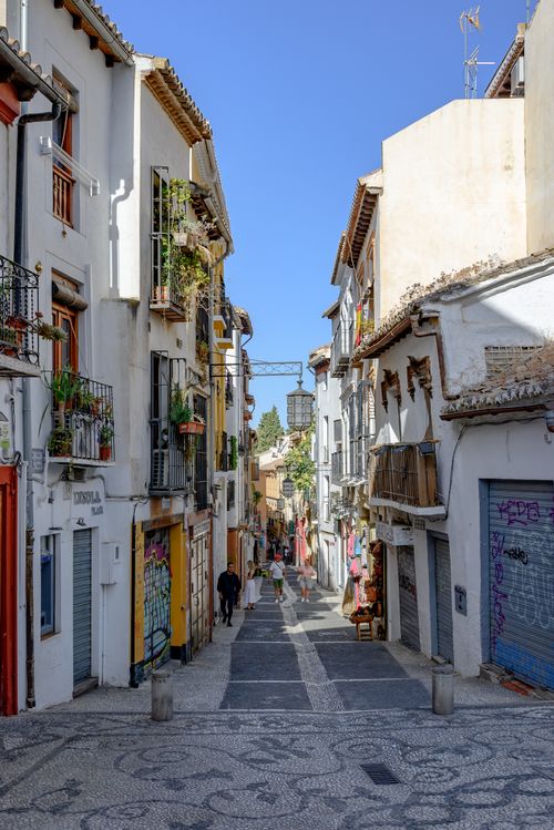 Free Picturesque street view in Granada's old town with traditional Andalusian architecture. Stock Photo