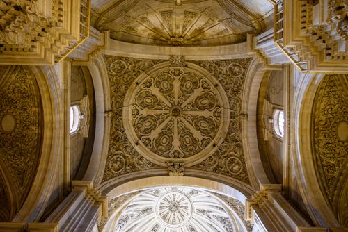 Free Stunning ornate ceiling design in Granada Cathedral, Andalucia, showcasing exquisite craftsmanship. Stock Photo