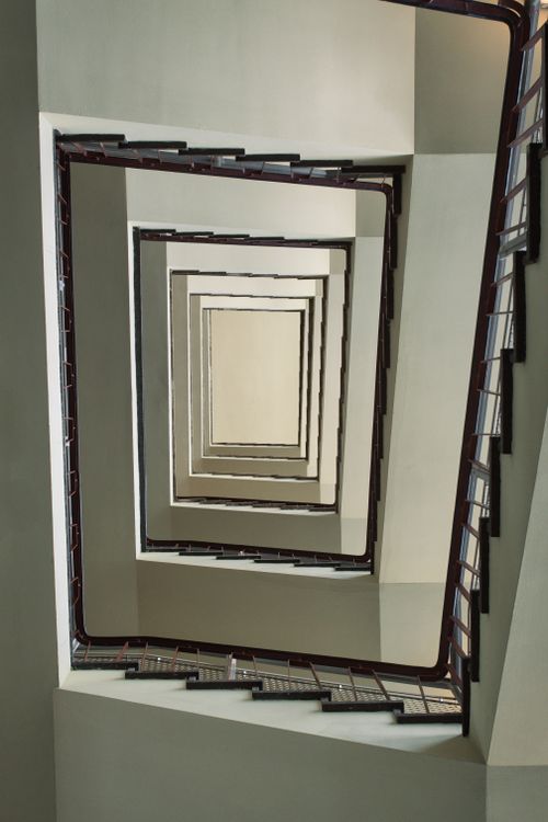Free Intriguing view of a spiral staircase in a Berlin building, featuring geometric lines and modern architecture. Stock Photo