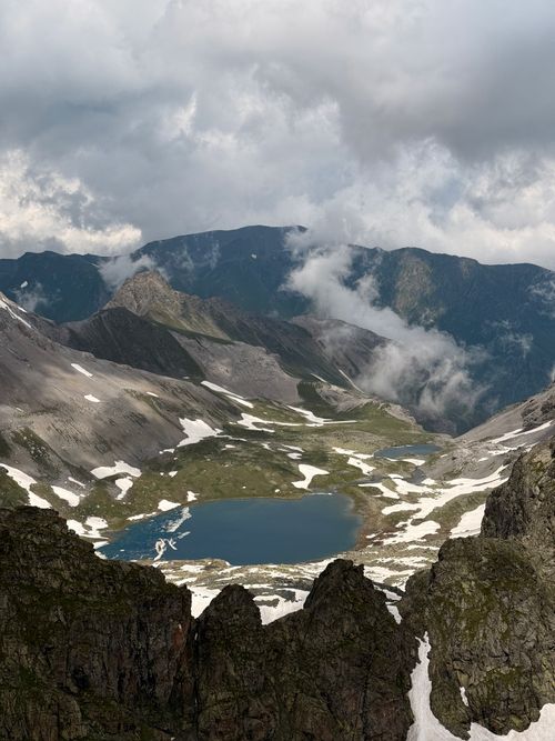 Free Breathtaking aerial view of Mount Kazbek with a stunning glacial lake surrounded by rugged peaks. Stock Photo