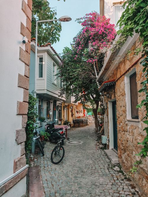 Free Picturesque narrow alley with blooming bougainvillea in a Mediterranean village, capturing tranquil charm. Stock Photo