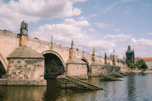 Free Picturesque view of the Charles Bridge arching over the Vltava River in Prague. Stock Photo