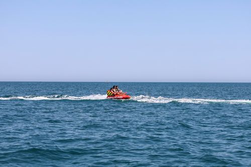 Free Exciting banana boat ride with people enjoying the Black Sea waves in Constanța, Romania. Stock Photo