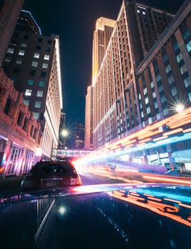 Long exposure of vibrant urban night scene in downtown Minneapolis with light trails and skyscrapers.