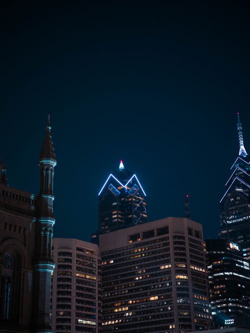 Free Dramatic night view of Philadelphia skyline with illuminated skyscrapers and historic architecture. Stock Photo