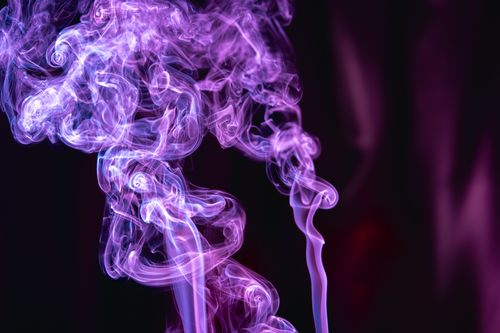 Free Artistic violet smoke swirls against a dark backdrop, ideal for creative projects. Stock Photo