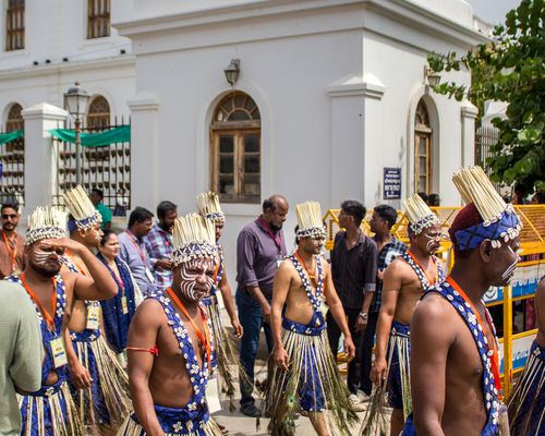 Free A vibrant cultural parade featuring traditionally dressed performers in an urban setting. Stock Photo