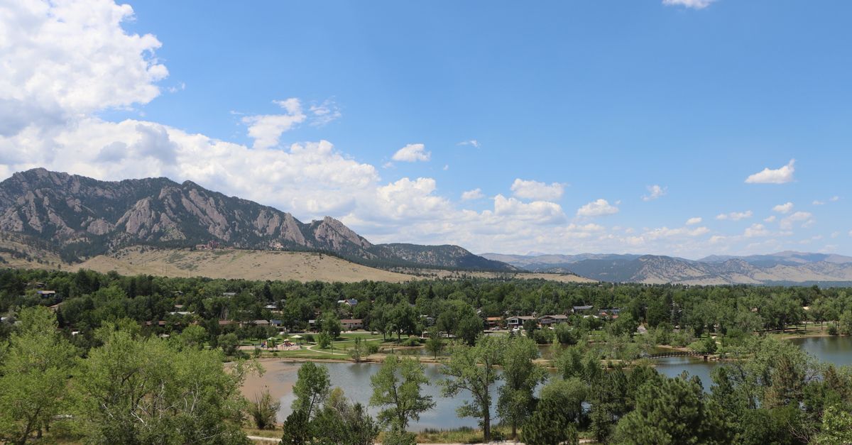 Captivating view of Boulder, Colorado's Flatirons with clear blue skies.